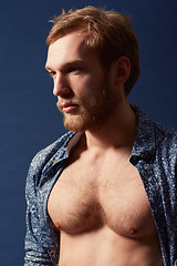 Image showing Fashion, thinking or model with chest in studio on a blue background wearing an open unbuttoned shirt. Ginger, body or handsome male person posing on color wall for masculine style, health or fitness