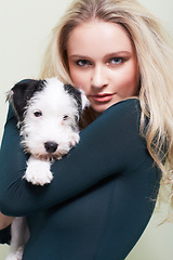 Image showing Portrait, hug and woman with a dog in her home with love, care and bonding, trust and chilling together. Puppy, love and face of female person embracing Jackapoo pet in house with support or security