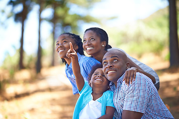 Image showing Happy family, children and pointing in forest for bonding, adventure or outdoor holiday in nature. African mother, father and kids smile for fun day in support, love or weekend exploring in the woods