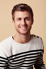 Image showing Fashion, confidence and portrait of happy man on beige background in trendy, stylish and casual clothes. Smile, attractive and person in stripe for positive attitude, pride and style in studio