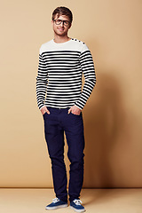 Image showing Fashion, confidence and portrait of man in studio in trendy, stylish and casual clothes on beige background. Happy, attractive and person with stripe style for positive attitude, pride and smile