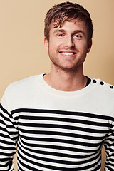 Image showing Fashion, happy and portrait of man in studio in trendy, stylish and casual clothes on beige background. Confidence, attractive and person with stripe style for positive attitude, pride and smile