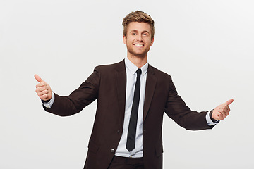 Image showing Portrait, thumbs up and celebration with a business man in studio isolated on a white background for success. Smile, target or goals and a confident young employee in a suit for an emoji hand gesture