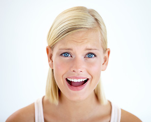 Image showing Portrait, surprise and woman in shock, mouth open and isolated on a white studio background. Face, wow and amazed model, young girl or blonde person with omg facial expression, announcement or gossip