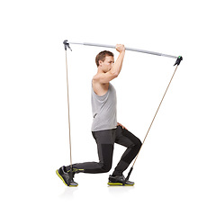 Image showing Fitness, workout and resistance band with a young man in studio isolated on a white background for health. Gym, exercise or performance and a strong athlete training with equipment for wellness