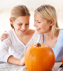 Image showing Happy, mother and child with pumpkin to celebrate halloween, party and fun together at home. Young girl, mom and family carving orange vegetable for holiday lantern, decoration or creativity of craft