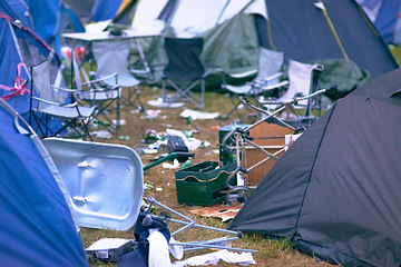 Image showing Tents, trash and mess at an outdoor music festival or event for a celebration party or social gathering. Summer, campsite and dirty with untidy camping gear, chairs or cooler boxes on the ground