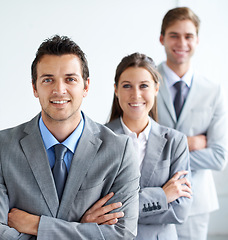 Image showing Businessman, portrait and leader with team, arms crossed and happy for future in finance career. Colleagues, accountants in suit and professional in workplace, people in background and confident