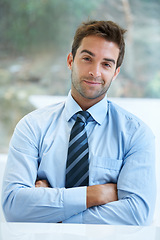 Image showing Portrait, smile and a business man arms crossed in the office with a mindset of growth or ambition. Company, corporate and trust with a confident young employee in the workplace as a professional