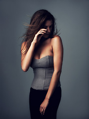 Image showing Fashion, edgy and woman on a grey background with serious style in a studio. Trendy, wall and female person with dark backdrop in a cool, edgy clothing outfit confidence and cool or trendy pride