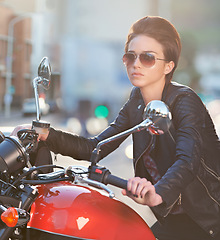 Image showing Motorcycle, power and woman in city with sunglasses for travel, transport or road trip as rebel. Fashion, street and model in leather jacket on classic or vintage bike for transportation or journey