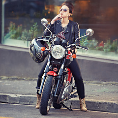 Image showing Motorcycle, leather and smoke with woman in city for travel, transport or road trip as rebel. Fashion, cigarette and sunglasses with model on classic or vintage bike for transportation or journey