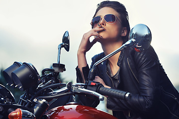 Image showing Bike, leather and woman smoking in city with sunglasses for travel, transport or road trip as rebel. Fashion, model and nicotine with attitude on classic or vintage bike for transportation or journey