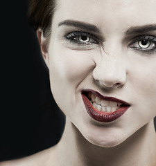 Image showing Portrait, woman and gothic makeup in studio for beauty, cosmetics and aesthetic with smirk, creepy and edgy. Face of model in villain character, cosplay and red lipstick on a dark or black background