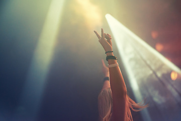 Image showing Dark, concert and excited woman with arms raised cheering for fun performance with culture. Party, event and new years eve with a female person celebrating nightlife entertainment and disco