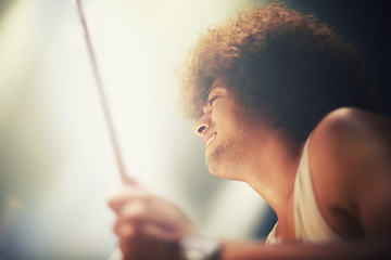 Image showing Man, drummer and musician in performance at stage for rock concert, music festival and energy. Person, artist and play wiht drumstick for entertainment, sound and rehearsal on percussion instrument