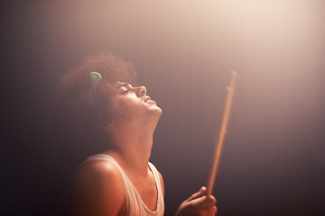 Image showing Man, drummer and musician in performance at rock concert, music festival on stage and talent. Person, artist and play on drumstick for entertainment, sound and rehearsal on percussion instrument