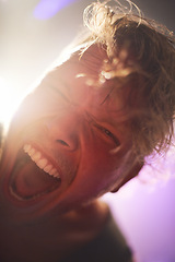 Image showing Portrait, closeup and man screaming for rockstar performance at concert for entertainment at night. Culture, yelling and face of musician male person with energy at festival for artistic expression