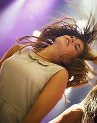 Image showing Music, concert and woman dancing at festival, party or celebration at social event at night. Sound, rhythm and young person at nightclub, disco or energy of fan at rave on holiday for entertainment