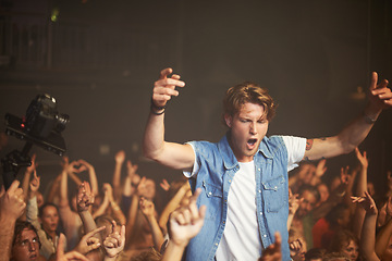 Image showing Shouting, concert and man excited at music performance and having fun. Social event, party and happy fan cheering for live show culture on new year eve with a crowd at the disco celebrating