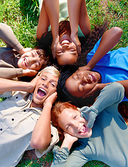 Image showing Children, friends and cover ears in outdoors for silence, quiet and ignoring noise in nature. Diversity, kids and laughing for humor or funny joke on grass, top view and bonding in childhood for fun