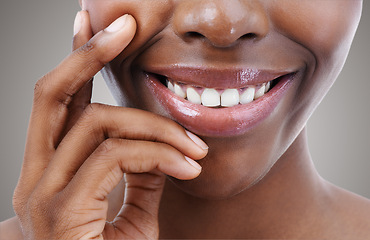 Image showing Smile, beauty and lips of black woman on gray background for wellness, cosmetics and makeup. Dermatology, teeth and closeup of natural face of person with gloss, lipstick and skincare in studio