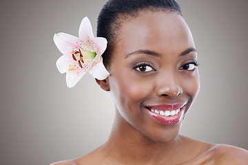 Image showing Portrait, smile for skincare and black woman with flower in studio on gray background for natural beauty. Face, wellness or spa and happy young person with orchid plant for aesthetic cosmetics