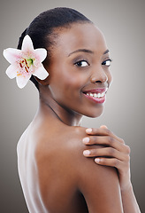 Image showing Skincare, beauty and portrait of black woman with flower on gray background for wellness, cosmetics and makeup. Dermatology, salon and person for aesthetic, natural face products and facial in studio