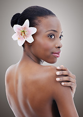 Image showing Natural, beauty and black woman with flower on gray background for wellness, cosmetics and makeup. Dermatology mockup, salon and face of person for aesthetic, skincare products and facial in studio