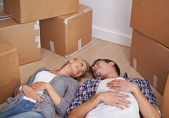 Image showing Couple, floor and moving or boxes for new home packing or real estate property to relax in marriage and apartment. Man, woman and rest or investment loan or mortgage for relocation, rent or buy