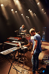 Image showing Electric, keyboard and musician at stage with band for preparation of production for concert. Sound, equipment and people in theater getting ready for creative show with dj, laptop and instruments