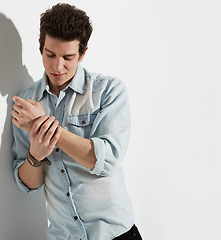Image showing Fashion, man and stylish clothes in studio on mockup space isolated on a white background. Cool, casual and young person in apparel, wear arm strap on hand and trendy model thinking on a backdrop