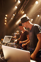 Image showing Electric, music and dj at stage for performance with sound board and laptop for production in concert. Audio, equipment and people in club with creative show mixing on turntable with techno at rave