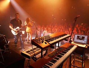 Image showing Concert, band and keyboard at stage for performance with singer and musician on guitar. Music festival, crowd and people with talent playing for audience in theater at night with spotlight and energy