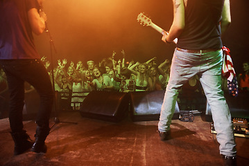 Image showing Music, concert and band on a stage with fans for performance with lighting equipment at party. Event, entertainment and group of musicians at festival, disco or rave with energy for crowd or audience