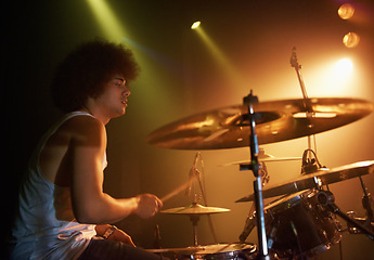 Image showing Stage, performance and man on drums at concert playing jazz, beat and talent for music. Drummer, musician and creative person in theater with rhythm for percussion, instrument or show at night