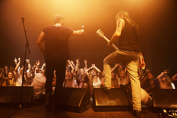 Image showing Music, concert and band on a stage with crowd for performance with lighting equipment at party. Event, entertainment and group of musicians at festival, disco or rave with energy for fans or audience