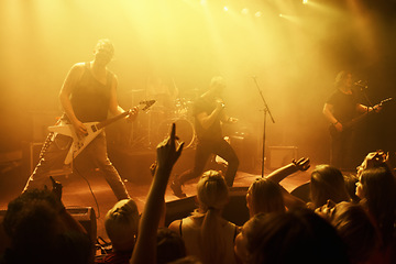 Image showing Music, concert and band on a stage with audience for performance with lighting equipment at party. Event, entertainment and group of musicians at festival, disco or rave with energy for crowd or fans