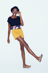 Image showing Fashion, happy and portrait of black woman on a white background in trendy, stylish and casual clothes. Confidence, hipster style and isolated person with smile, glasses and accessory in studio