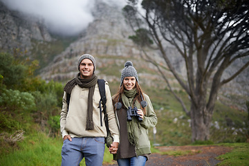 Image showing Couple, portrait and hiking on mountain or holding hands with travel, adventure or holiday for experience or love. Man, woman and trekking outdoor on trail for cardio, exercise or happy and binocular