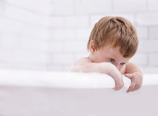 Image showing Baby, bath and washing with bubbles and thinking in the bathroom at home for hygiene. Grooming, brunette and boy child cleaning for bodycare in the house while curious for development and growth