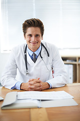 Image showing Happy, confident and portrait of doctor in office for consultation with positive and good attitude. Smile, career and professional young male healthcare worker with pride at desk in medical clinic.