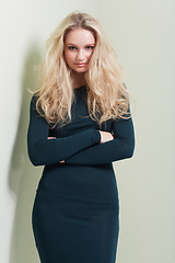 Image showing Fashion, portrait and woman in studio with arms crossed, confidence and elegance against wall background. Classy, style and face of young female model in stylish outfit choice, clothes or attitude