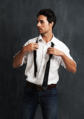 Image showing Serious, fashion and young man in a studio with formal, cool trendy and elegant outfit with confidence. Pride, handsome and male model from Canada with classy style posing isolated by gray background