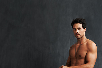 Image showing Portrait, fitness model and man shirtless, strong and muscular results from strength training, body building and workout. Bodybuilder, chalkboard mockup space and studio person on black background