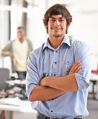 Image showing Arms crossed, smile and portrait of business man in startup agency for creative, manager and designer. Professional, consultant and advisor with face of employee in office for entrepreneur career