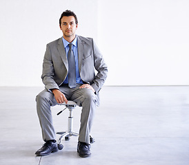Image showing Portrait, serious and business man on chair in office, workplace or corporate company on mockup space. Confident professional, employee and worker, lawyer and attorney in suit for career in Spain