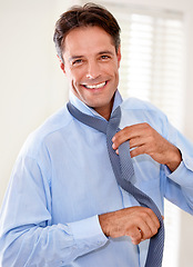 Image showing Portrait, tie and happy businessman dressing in home, job or entrepreneur preparation in the morning. Face, professional and getting ready for working, person tying necktie and consultant in house