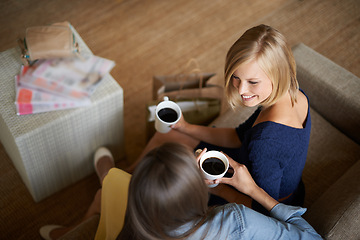 Image showing Friends, women and drinking coffee from above to relax on the sofa at home. Female people, smiling and bonding with care to rest with tea drinks and conversation after retail shopping