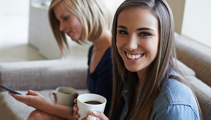 Image showing Portrait, friends and drinking coffee while relaxing on the couch with a phone for social media. Face, women and smiling on sofa in the living room for smartphone meme or media online and bonding